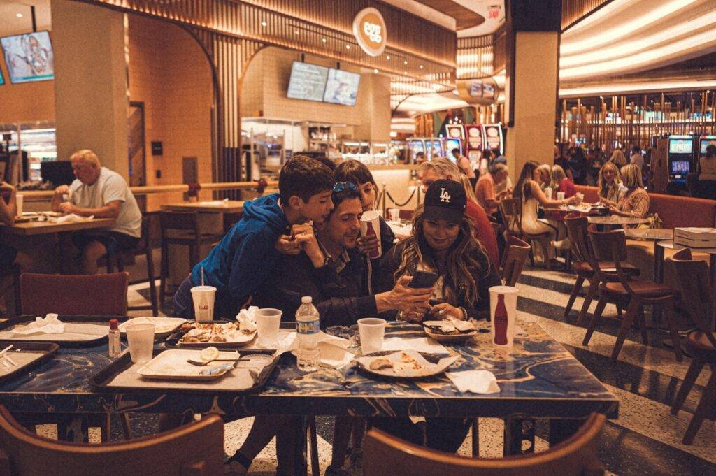 A family gathered around a table at a neighborhood café, sharing a meal in a comfortable and friendly setting.