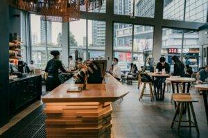 A bustling Cafe Singapore with patrons enjoying coffee at tables, creating a lively and inviting atmosphere.