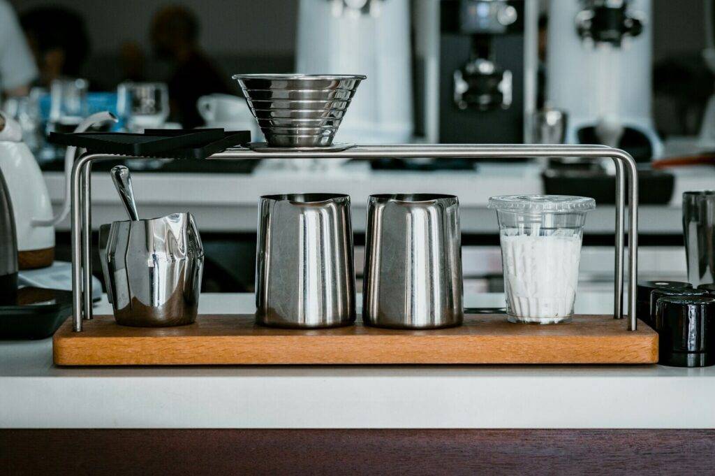 A coffee cup, and a cup holder, representing the essentials of Singapore coffee shops.