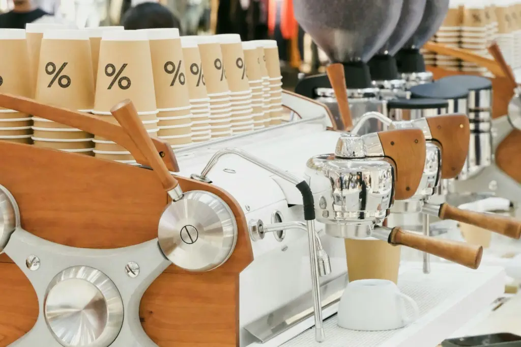 A row of coffee machines in a bustling Singapore coffee shop, showcasing various brewing styles and equipment.