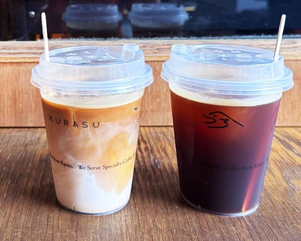 Two glasses of iced coffee placed on a café table, with visible condensation on the glass and a clean, modern café background that emphasises a refreshing and stylish coffee experience.