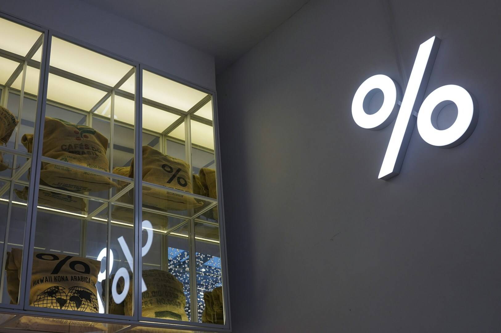 A wall sign displaying the percentage symbol (%) in a coffee shop in Singapore.