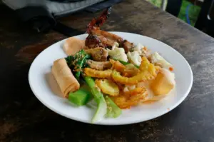 A plate of Singapore brunch featuring various traditional dishes, elegantly arranged on a table.