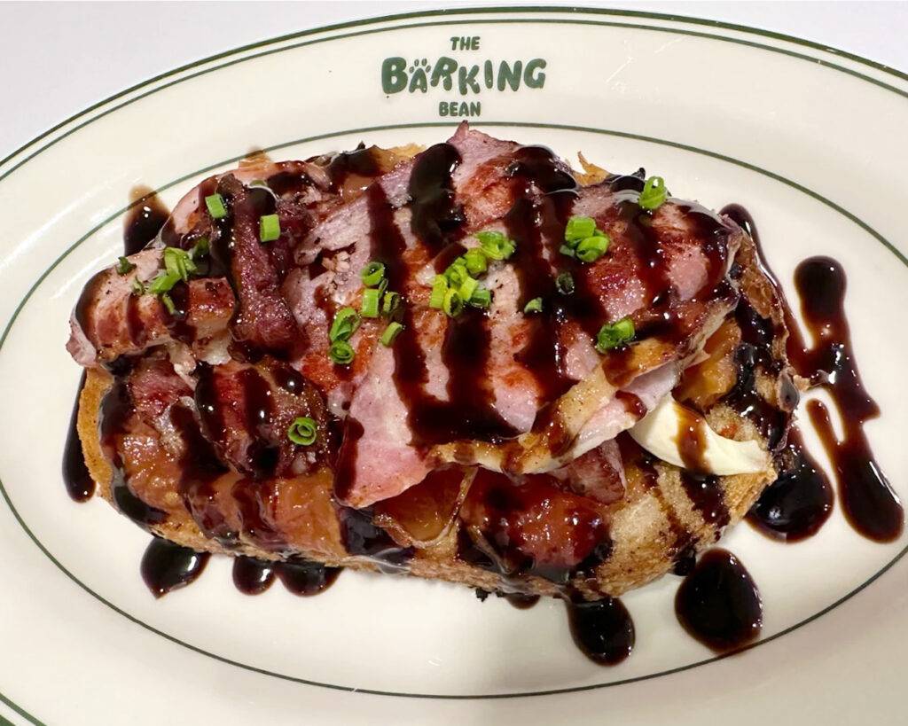 Plated dishes served at The Barking Bean Singapore, featuring freshly prepared meals with colourful presentation on a café table.