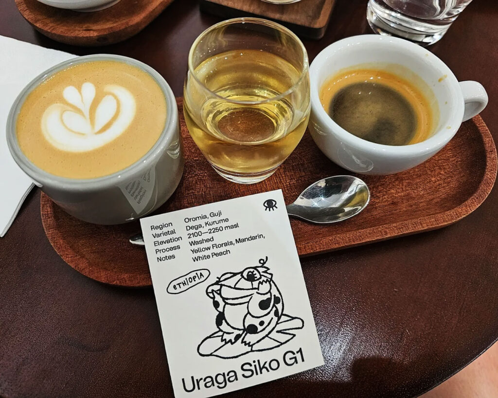 Two cups of coffee and one cup of tea arranged neatly on a table at Flip Coffee Roasters, showing a casual café setting with a clean, minimal presentation ideal for sharing.
