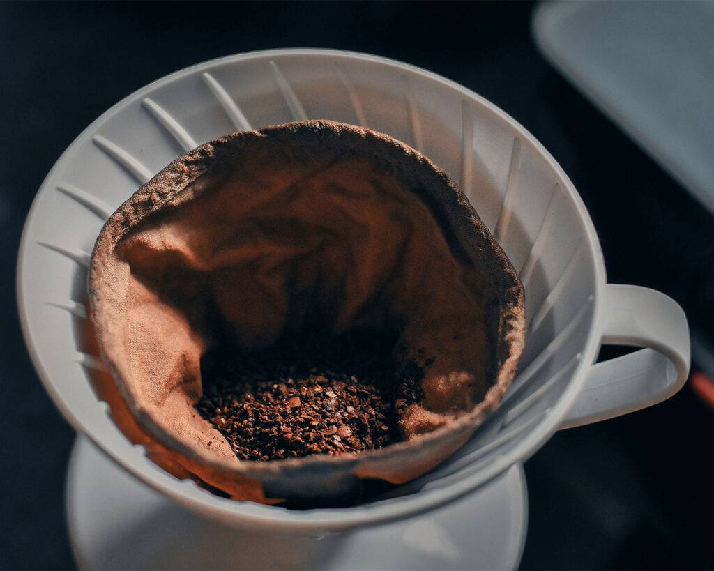 Ground coffee in a brewing to show the freshness and warmth of the brewing process