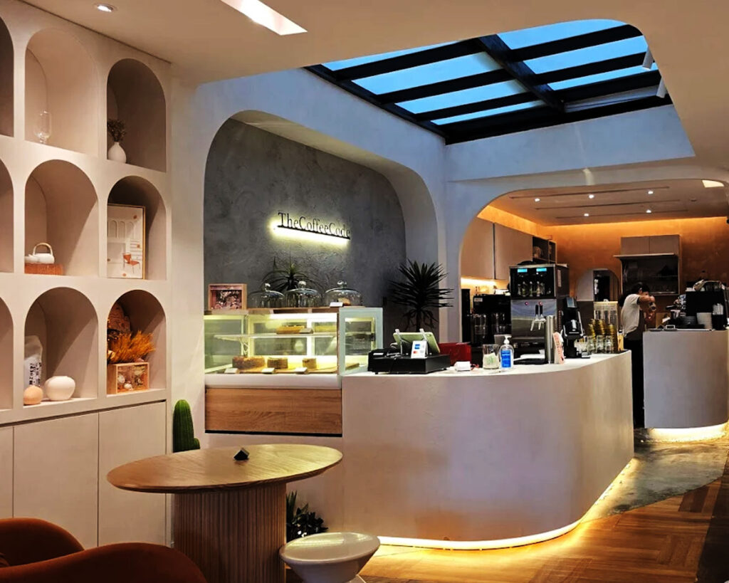 The interior of The Coffee Code café, showing modern décor with seating and counter space, creating a relaxed and welcoming atmosphere for customers to enjoy coffee indoors.