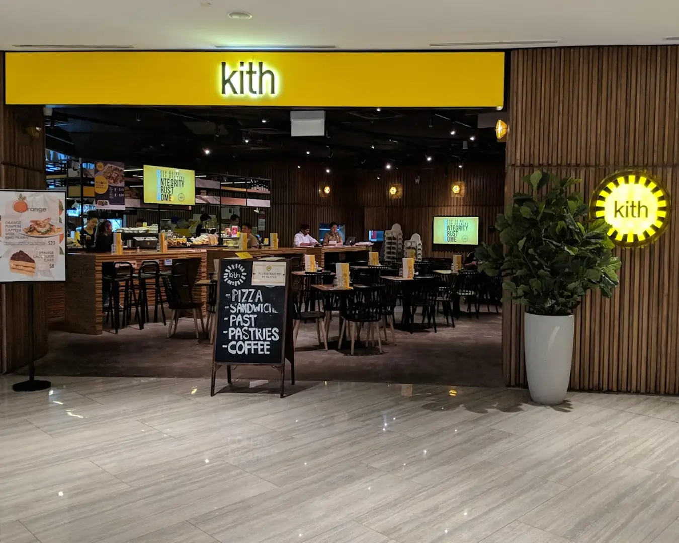 Exterior view of Kith Café storefront with its signature signage displayed above the entrance, showing the welcoming café setting from the outside where customers can step in for brunch, coffee, and casual dining.