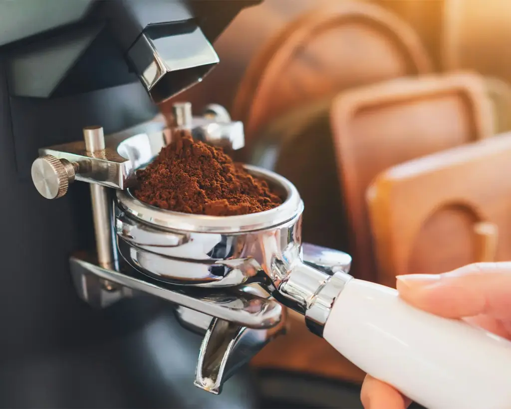 Finely ground coffee piled softly, with a rich, earthy texture that suggests readiness for brewing, emphasising the importance of grind size in flavour extraction.