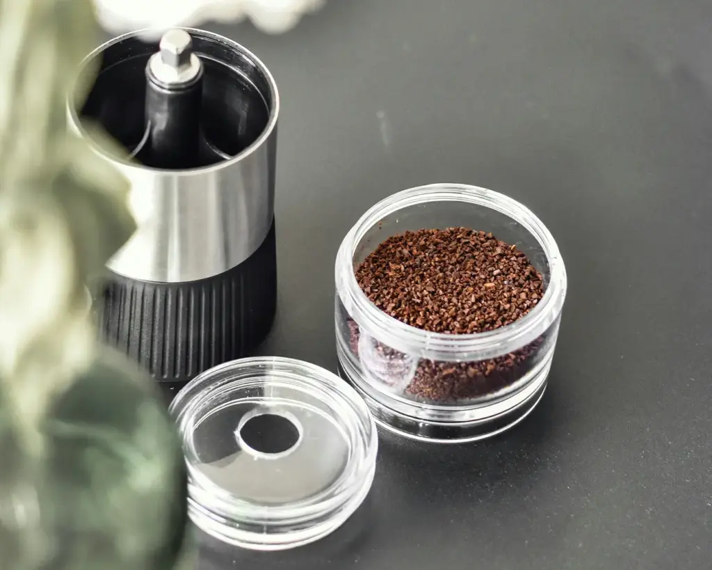 Freshly ground coffee powder collected after grinding, displaying its fine, crumbly texture that enhances flavour extraction during brewing.