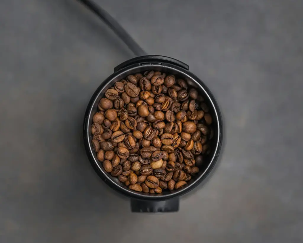 Recently roasted coffee beans cooling after the roasting process, revealing their deep colour and fragrant aroma