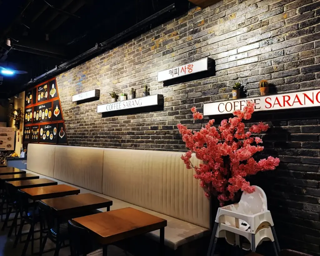 The interior of Coffeesarang café, showing a cosy and stylish Korean café setting with comfortable seating and a relaxed ambience for enjoying coffee and desserts.