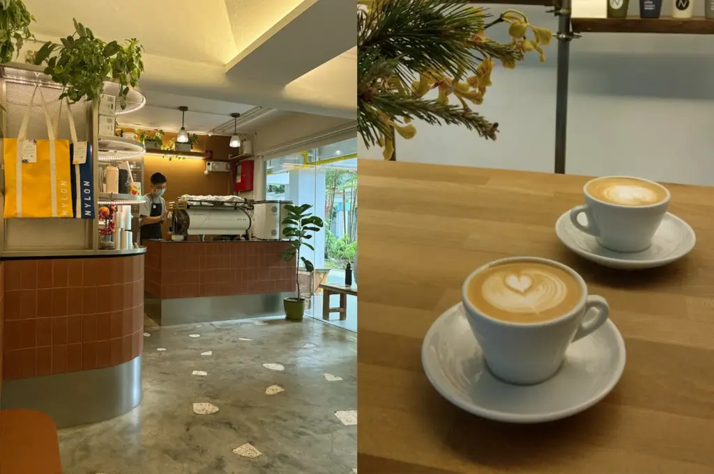 Interior view of Nylon Coffee Roasters featuring a cozy, minimalist coffee bar with warm lighting and fresh cups of latte art, highlighting a top-rated cafe near Maxwell Food Centre.