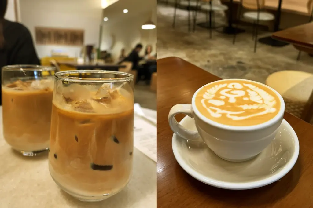 Close-up of iced Orange Mocha and a flat white with artistic latte art at Acoustics Coffee Bar on Neil Road.