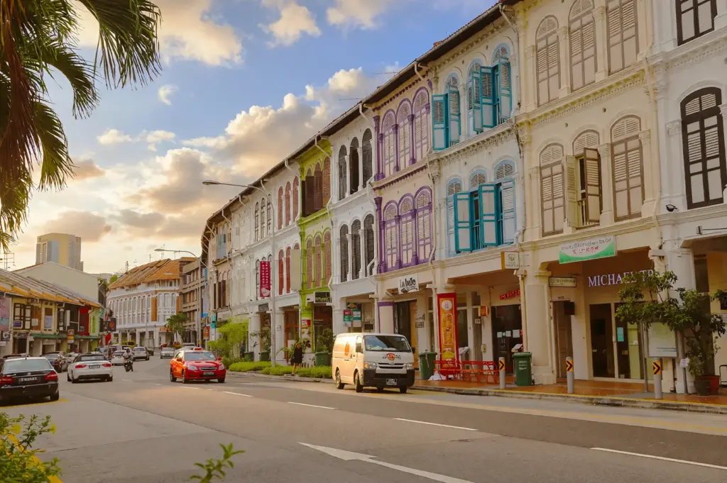 A street-level view of colorful, historic shophouses in Singapore, showcasing the Tanjong Pagar area within the Central Business District, a prime location when visiting Singapore and for remote workers seeking unique, work-friendly café culture and coffee spots.