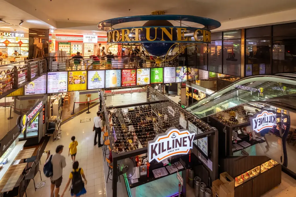 Interior view of the multi-level atrium at Fortune Centre, showcasing various cafes, and other restaurants.