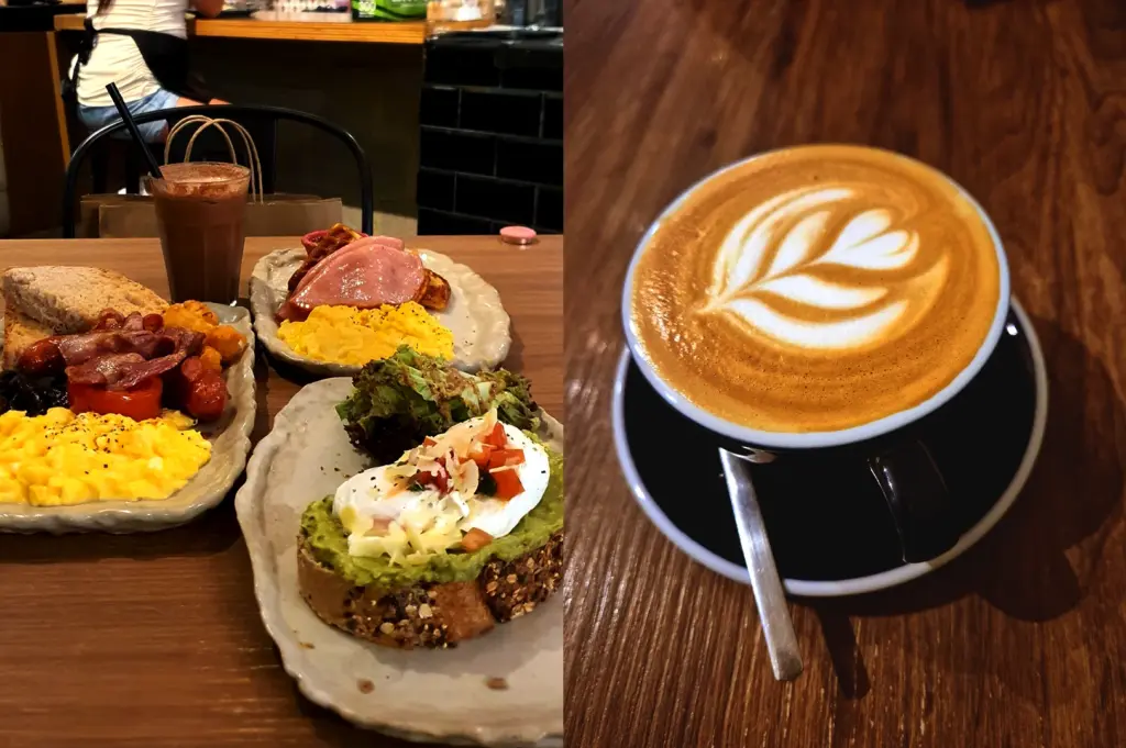 Close-up of a delicious brunch spread at The Clueless Goat, featuring avocado toast, scrambled eggs, bacon, and a perfectly crafted latte with coffee art.