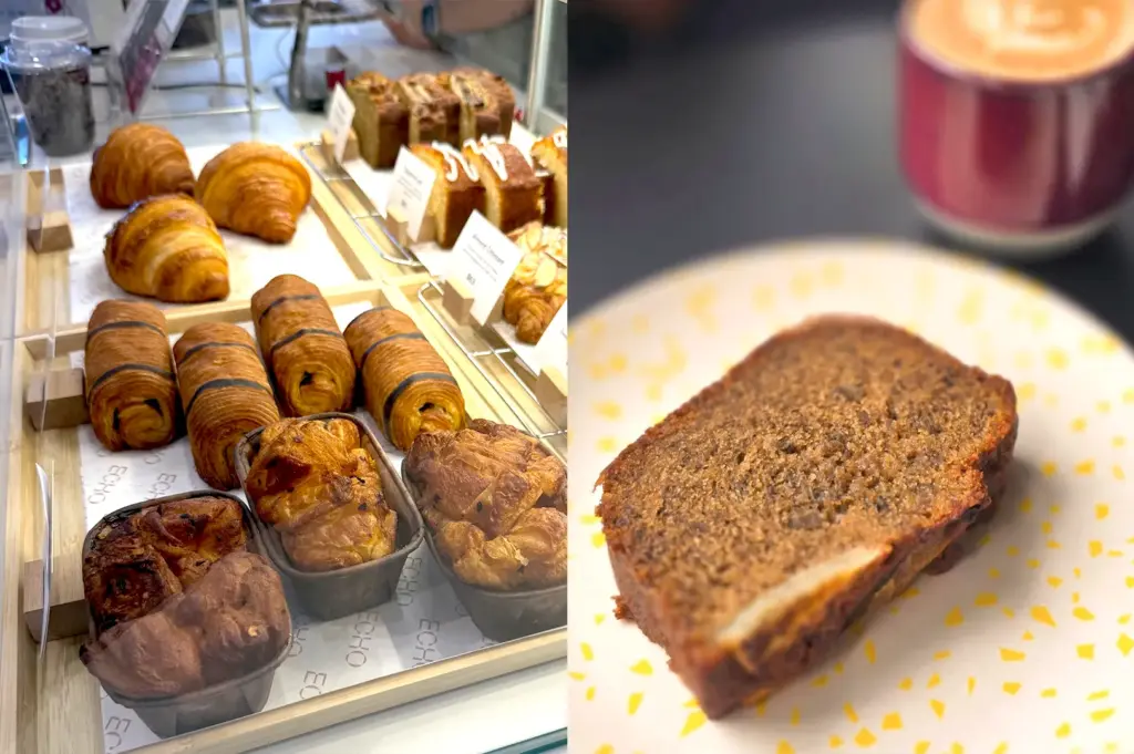 A selection of fresh pastries and cakes displayed at the Echo Cafe counter, including croissants and a slice of the signature Pisang Loaf on a decorative plate, perfect for a mid-day treat.