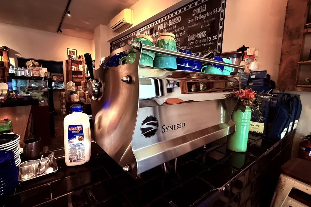 Professional espresso machine at the coffee bar inside The Clueless Goat, showcasing their commitment to high-quality specialty coffee.