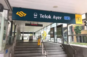 Entrance sign at Telok Ayer MRT Station (DT18), a key transit stop providing easy access to popular cafes and brunch spots in Singapore.-