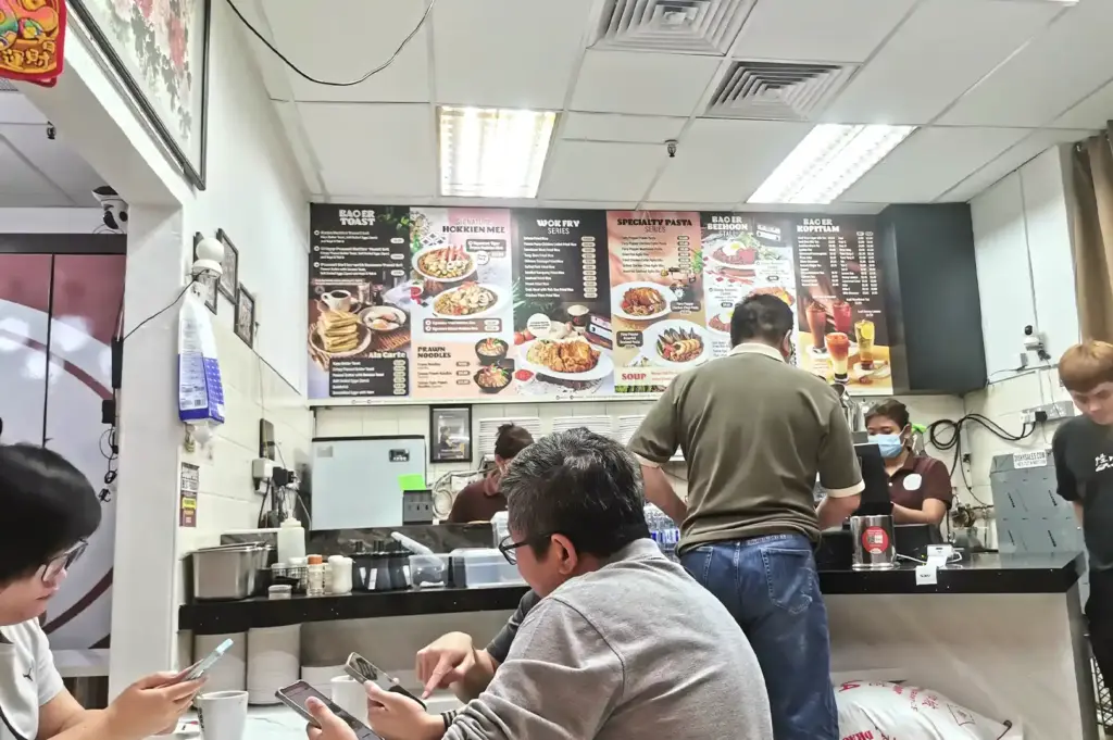 Menu boards and counter view at Bao Er Cafe Singapore, featuring traditional local breakfast items, wok-fry dishes, and beverages.