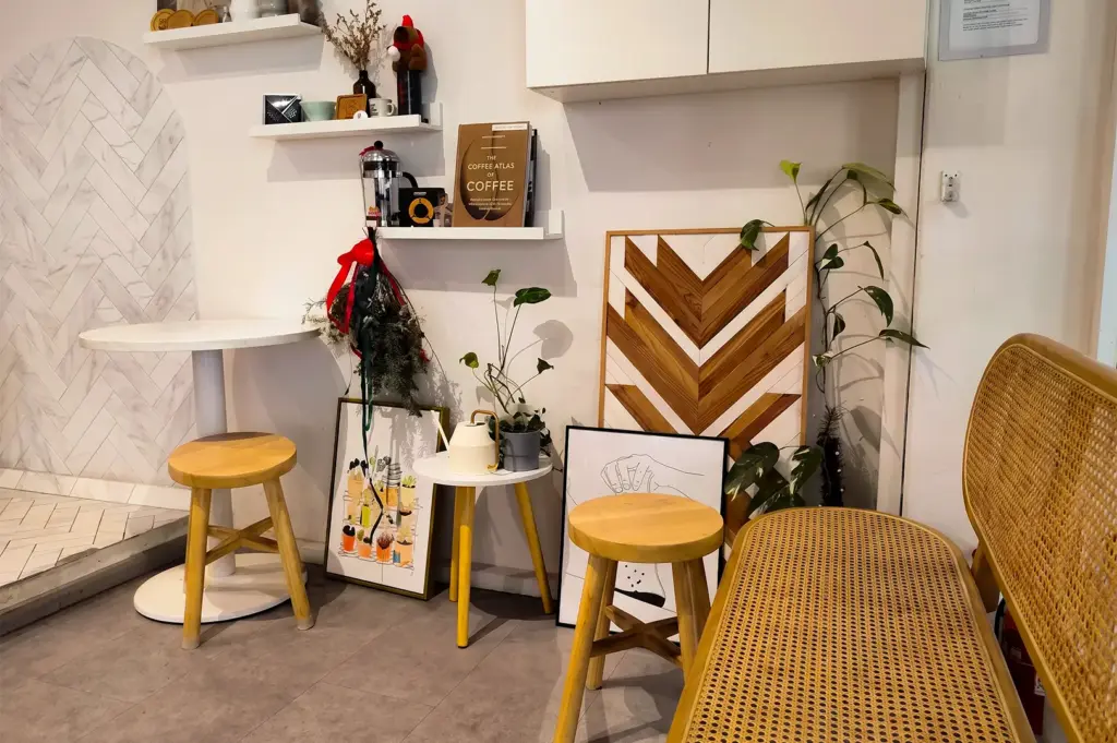 Zerah Coffee Roasters interior with its creative paintings and cozy furniture displays against a wall.
