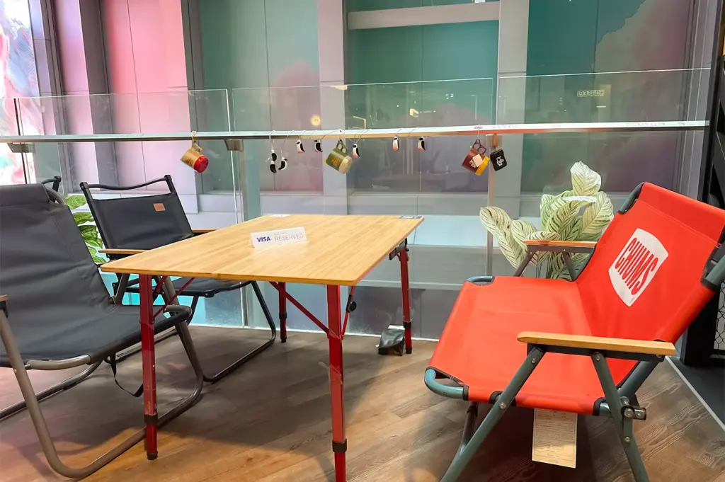 For You People Cafe table and chairs with different color with plant decors on the side.